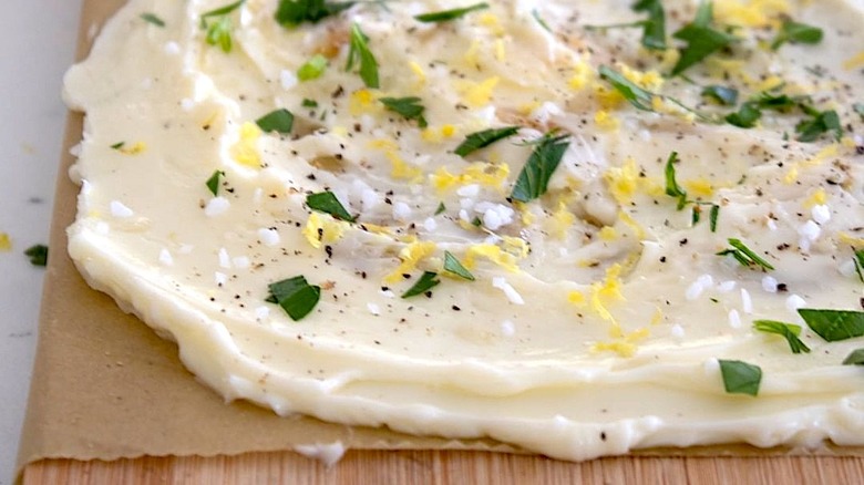Butter board with salt, lemon, and hebs