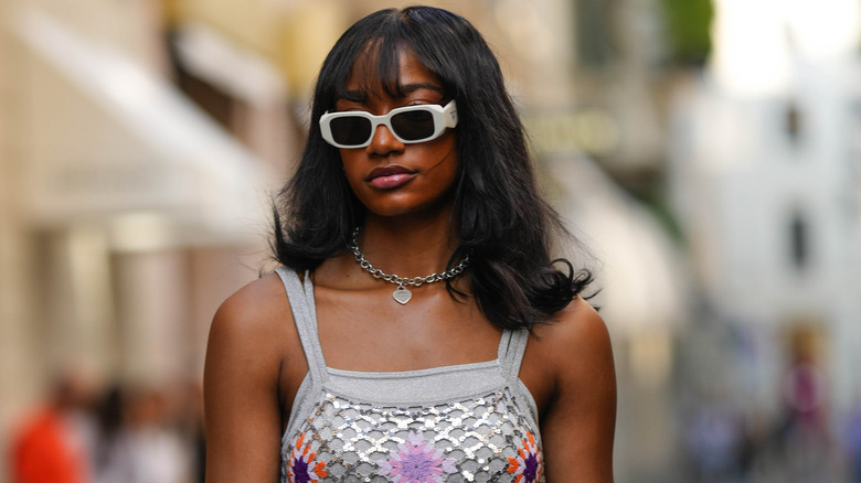 woman wearing silver heart necklace