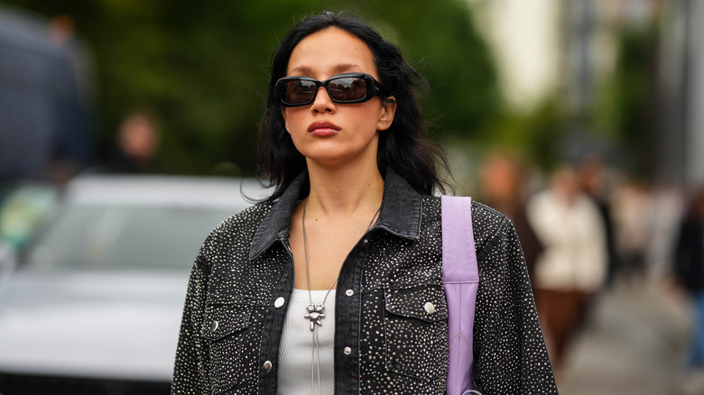 woman wearing long pendant necklace