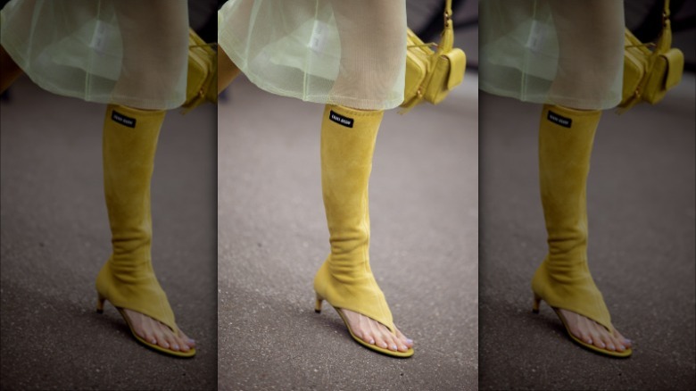 Woman wearing chartreuse knee-high heels