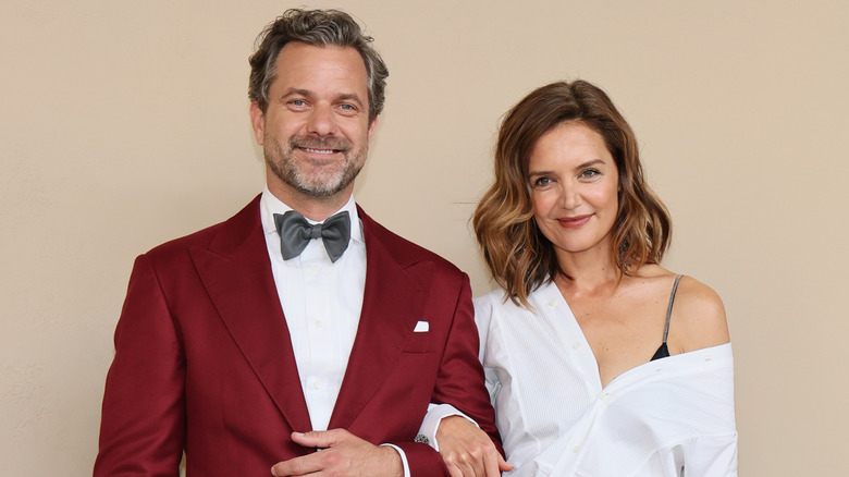 Katie Holmes wraps her arm through Joshua Jackson's at an event they attended together