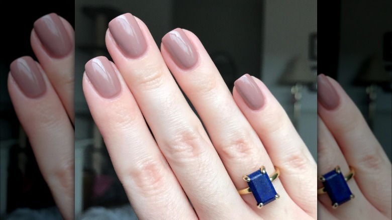 hand with brown nail polish