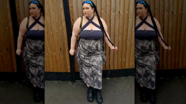 woman wearing chunky boots with a midi skirt