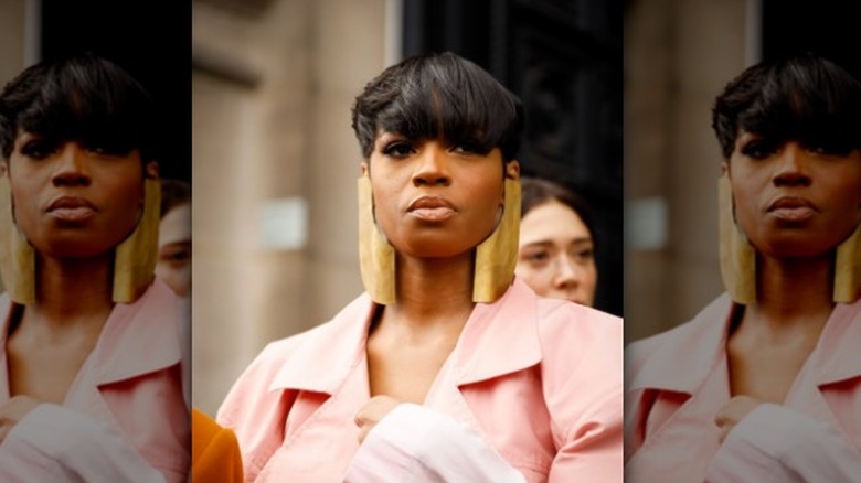 woman wearing thick gold earrings