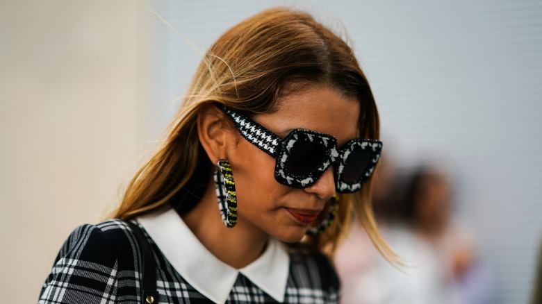 woman with plaid chunky hoops
