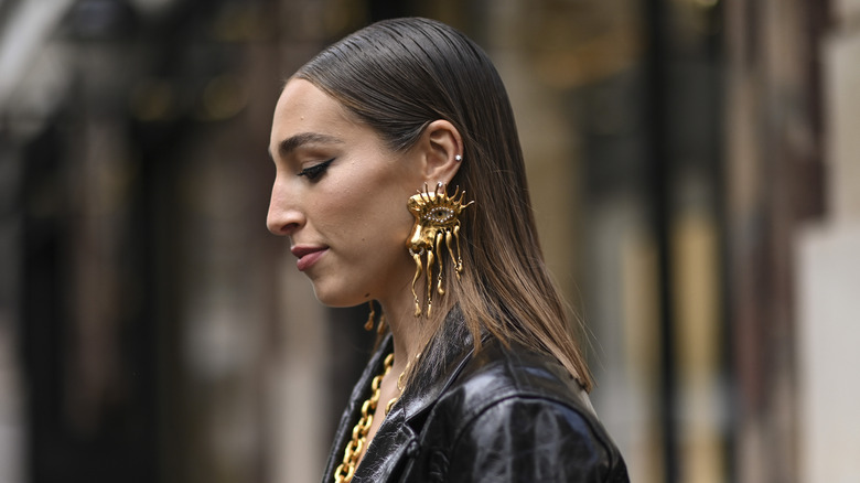 woman with chunky evil eye earrings