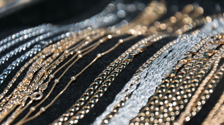 Gleaming silver and gold necklaces