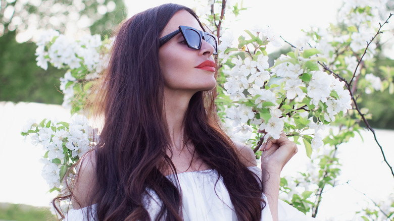 woman smelling flowers