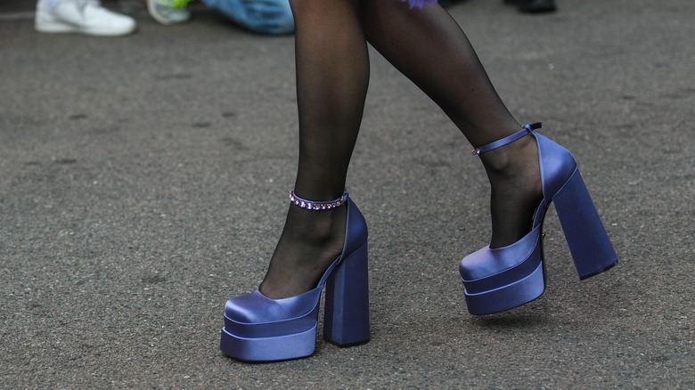 woman wearing blue satin platforms