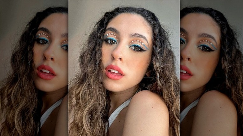 woman with pearls and graphic eyeliner 