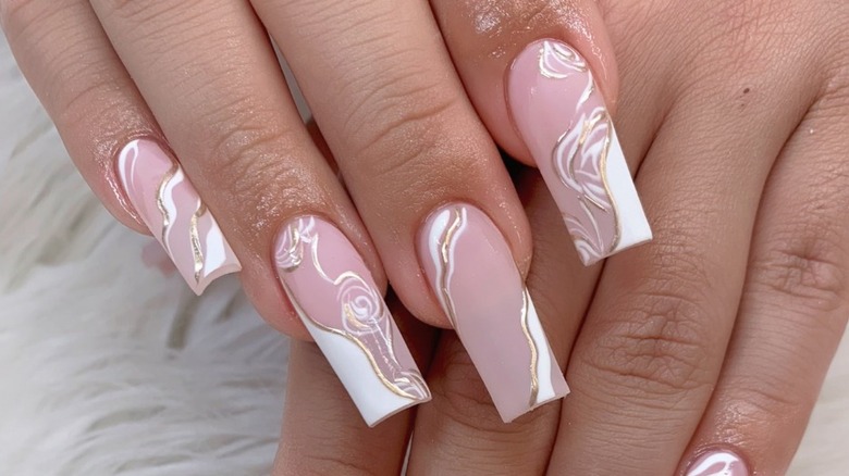 hands with coconut milk nails