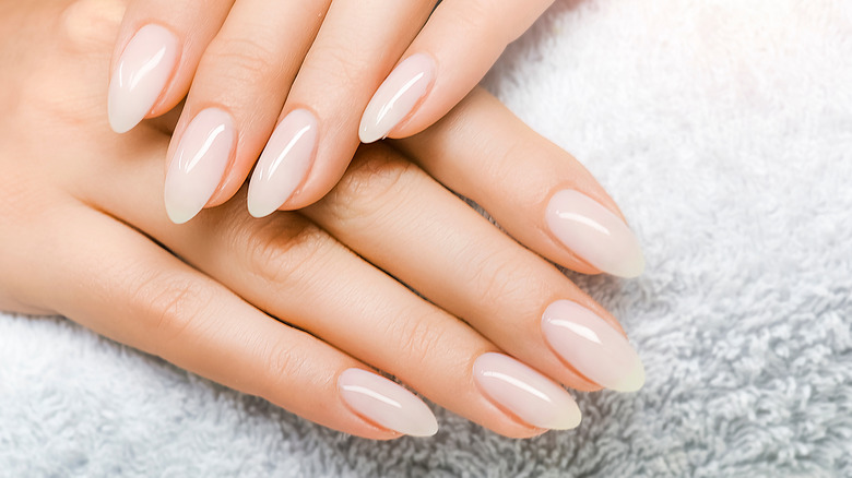 hands with coconut milk nails