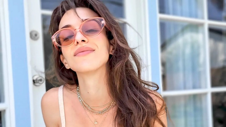 Woman wearing pale pink sunglasses