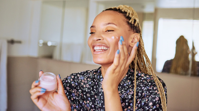 woman with skincare product