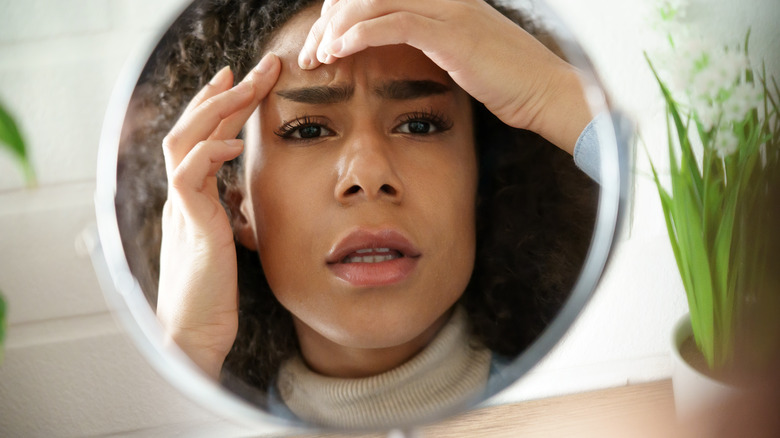 Woman looking in mirror