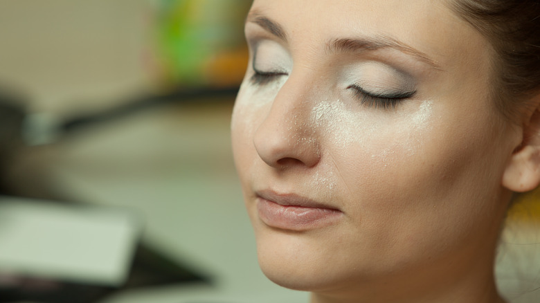 A woman applying powder