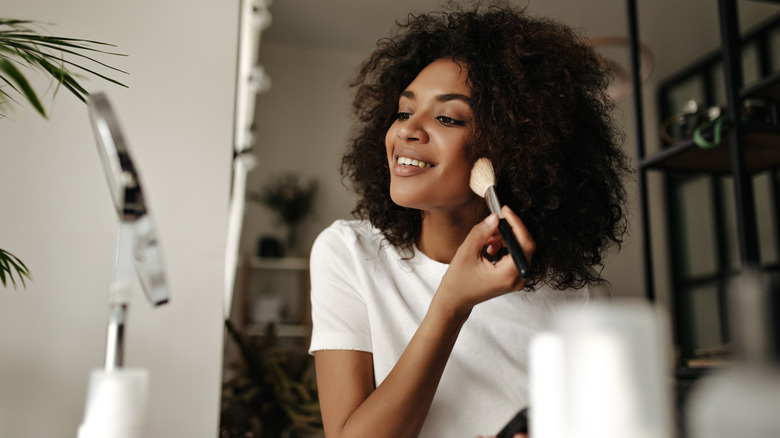 A woman applying contour