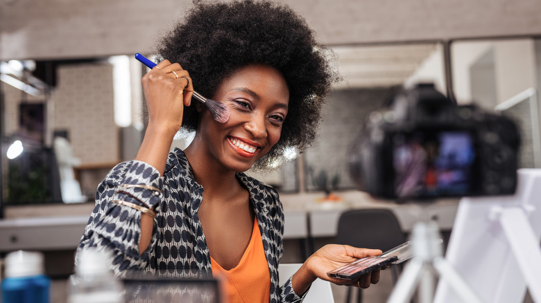 A woman applying highlighter