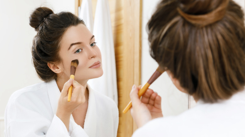 A woman applying foundation