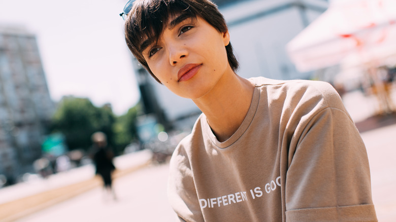 Short-haired woman wearing slogan tee