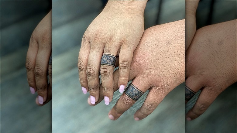 couple wearing wedding ring tattoos