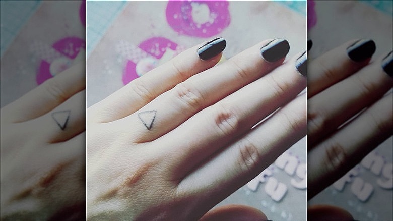 woman with delta finger tattoo