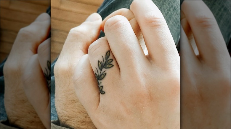 couple with leafy branch wedding ring tattoos
