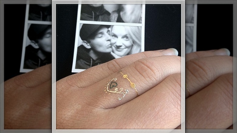 woman wearing metallic wedding ring tattoo