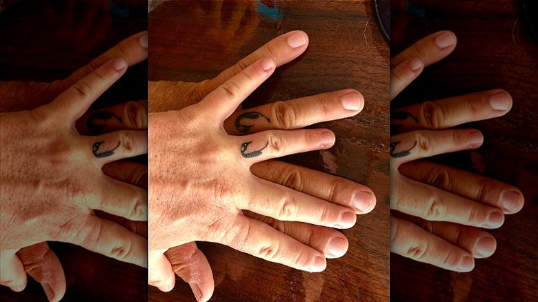 couple with penguin wedding ring tattoos