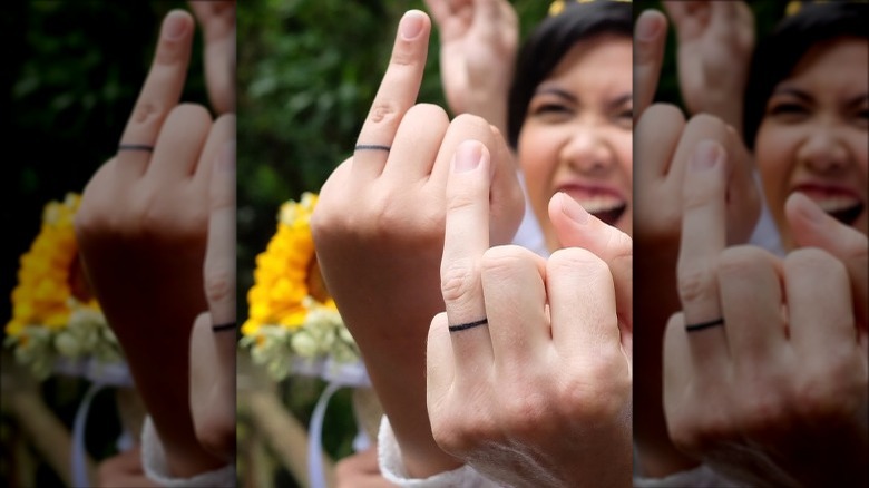 couple wearing wedding band tattoos