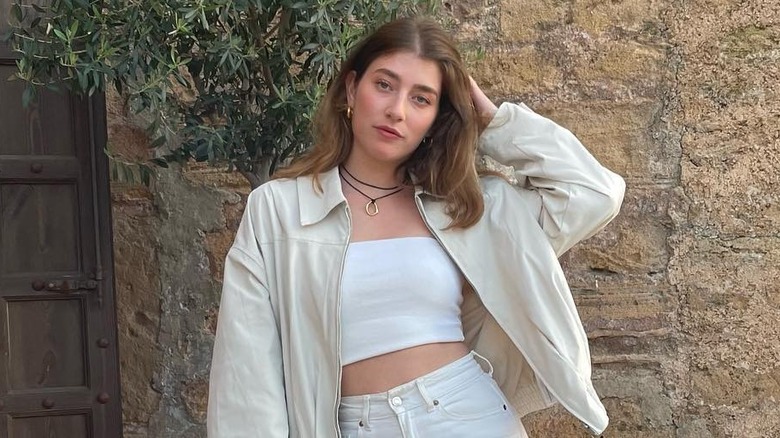 Woman wearing two black cord necklaces