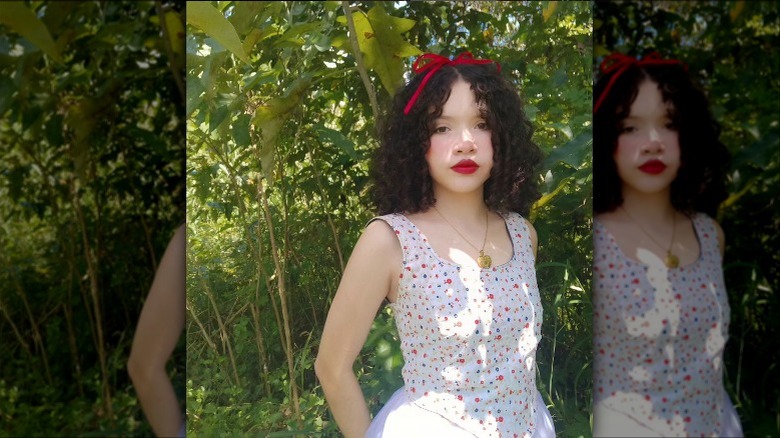 woman standing in front of greenery
