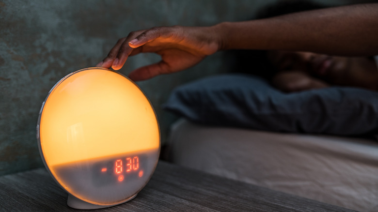 Woman using sunrise night light