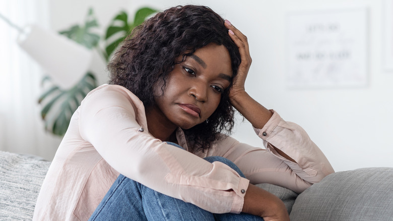 anxious woman sitting at home