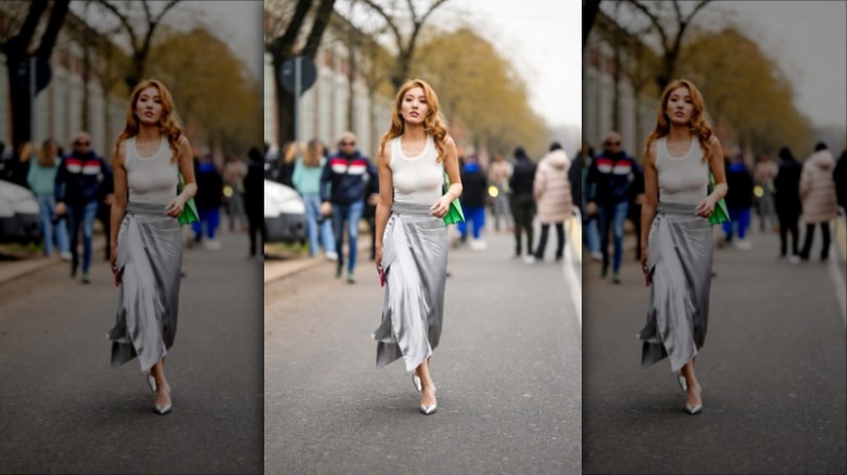 woman wearing a white tank top and a silver slip skirt