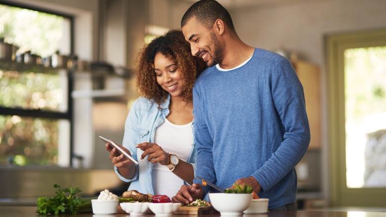 Couple cutting up whole foods