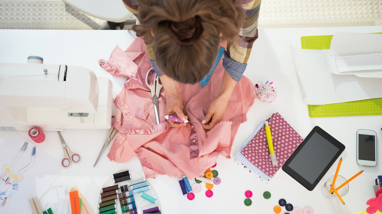 Woman sewing on a shirt