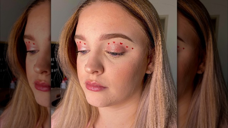 A woman with red hearts on her eyelids