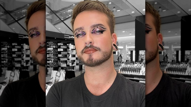 A man with black graphic eyeliner