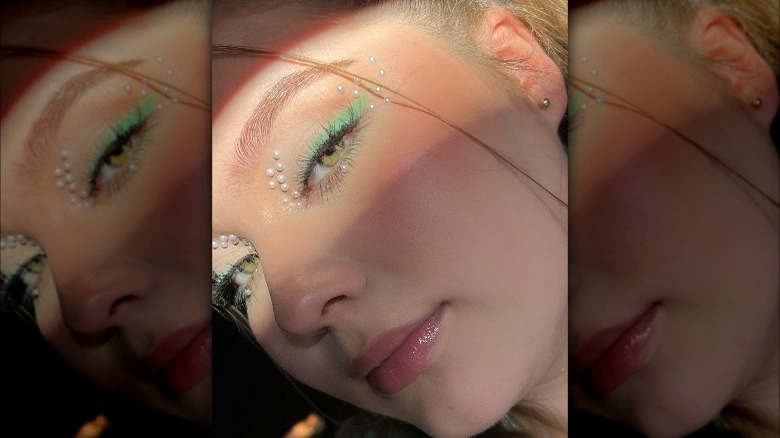 A woman with pearls on her face