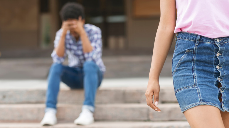 Woman walking away from man 