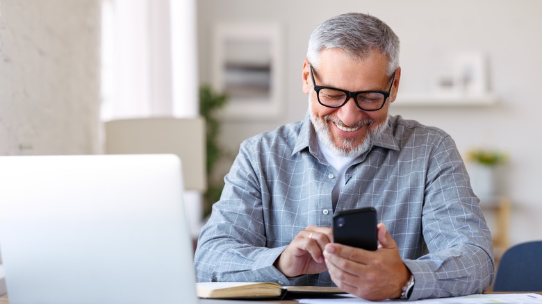 Happy man using his phone