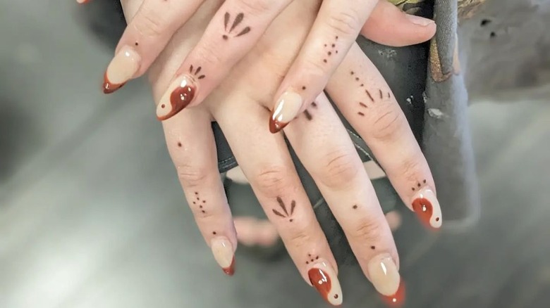 minimal dot style finger tattoos