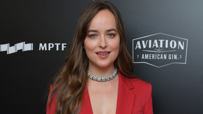 Dakota Johnson on the red carpet in a red blazer