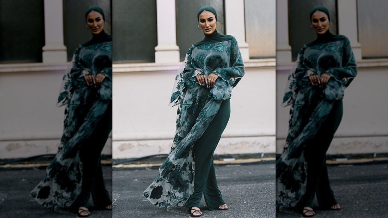 Woman wearing green sheer floral shawl