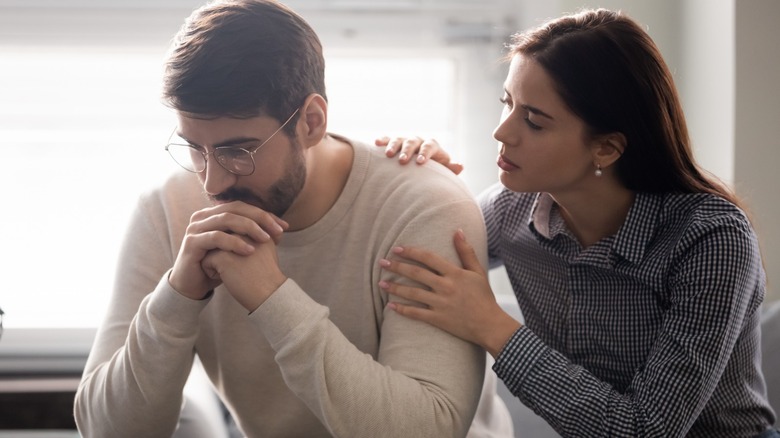 Woman hugging sad man