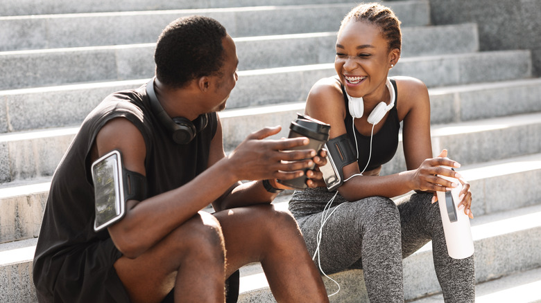 Couple workout gear laughing