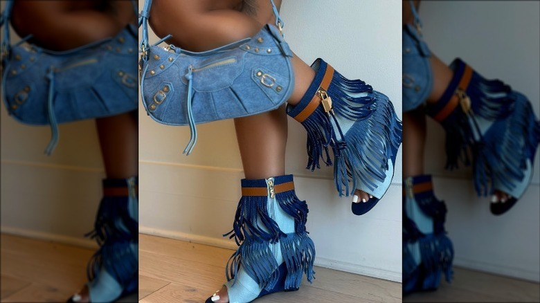 Person wearing denim boots, handbag