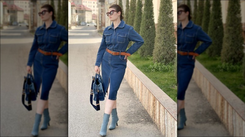 Woman wearing belted denim dress, boots