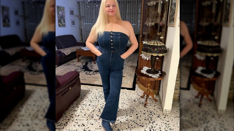 Woman wearing denim jumpsuit, boots